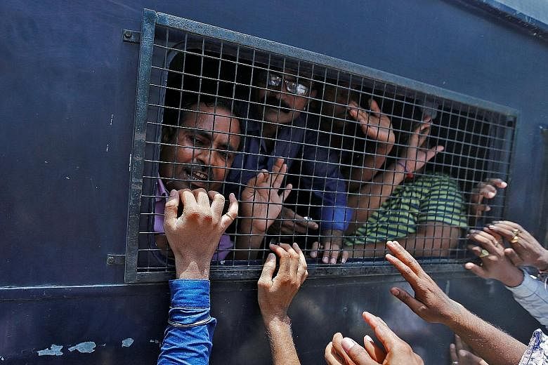 Some of those convicted over the 2002 Gujarat riots in a police van outside a court in Ahmedabad in India earlier this month. The riots have long dogged PM Modi, who was accused of turning a blind eye to the violence as chief minister of the state.