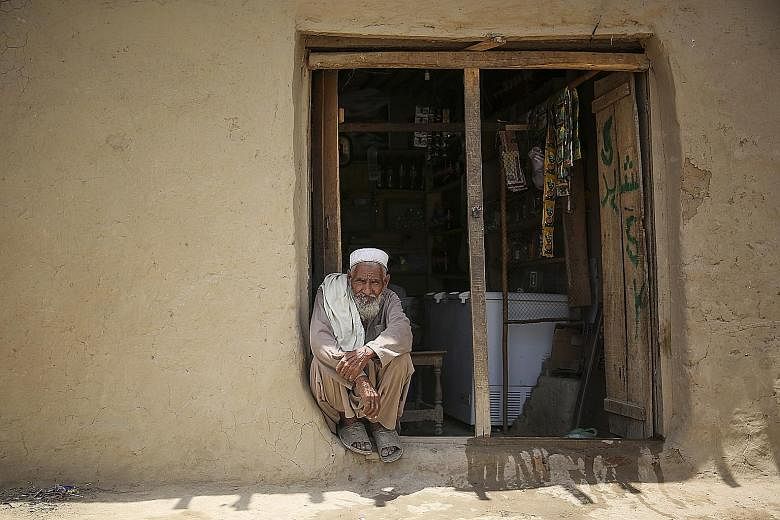 An Afghan refugee outside a grocery store in Utmanzai refugee camp. He is but one of at least 1.5 million documented refugees caught in the middle of a wider spat involving Afghanistan, Pakistan and the US. Pakistan wants all the refugees gone by the