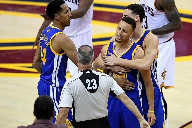 Golden State's Stephen Curry is floored after colliding with LeBron James while going for a loose ball in the first half. Two early fouls against Curry, who was later ejected, helped set the tone for Cleveland's 115-101 home victory in Game 6 on Thur