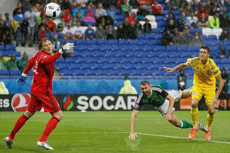 Gareth McAuley (middle) of Northern Ireland scoring the opening goal in the 2-0 win against Ukraine on Thursday. "We've got a big game to look forward to in Paris," he said of the looming clash against Germany.