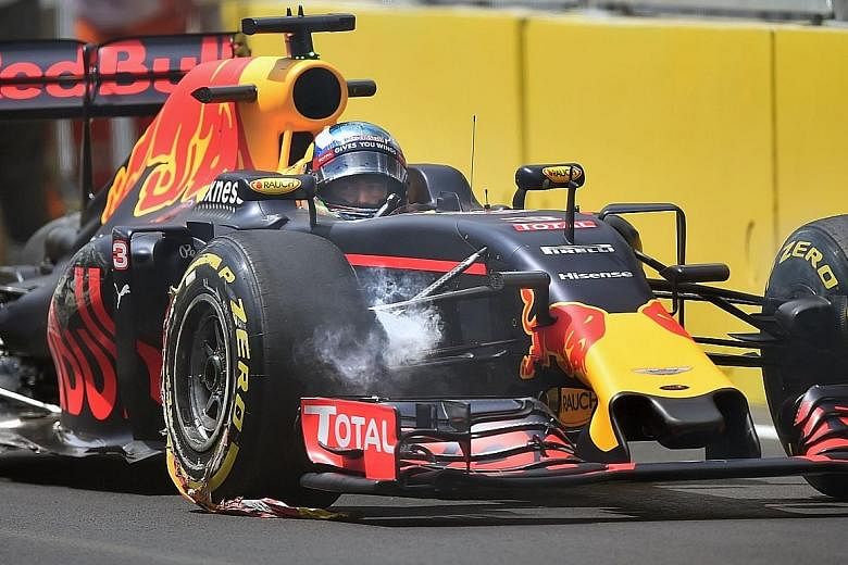 Red Bull driver Daniel Ricciardo sits in his damaged car after swiping a wall during a practice session for the European GP. The metal kerbs used at the Baku circuit have been criticised, with experts weighing in on safety concerns.