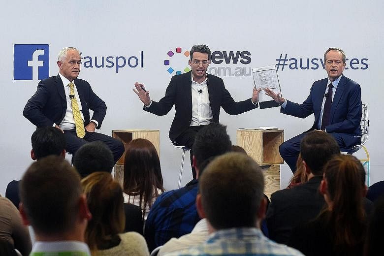 Mr Turnbull (left) and Mr Shorten (right) with moderator Joe Hildebrand during last night's debate, which was live-streamed via Facebook Live and broadcast on television. The Australian election will be held on July 2.