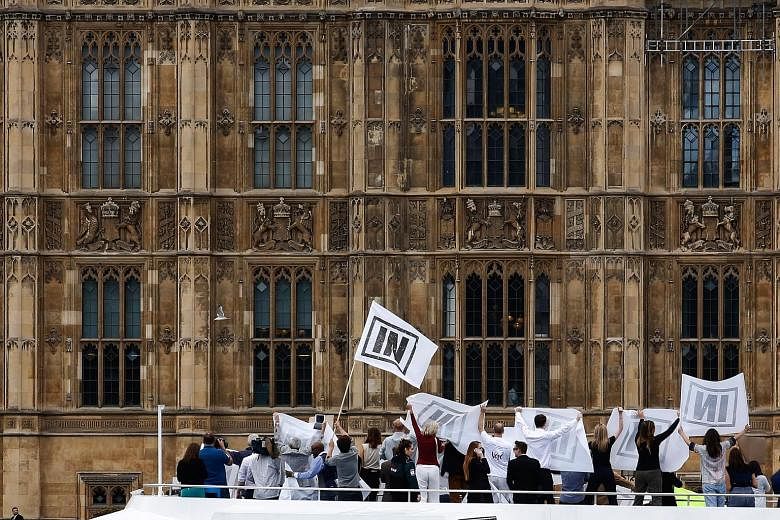 A supporter of the UK Independence Party, which is campaigning for Britain's exit from the EU. Supporters of the "Remain" campaign demonstrate on the deck of a boat outside the Houses of Parliament in London. A vote in favour of Brexit is expected to
