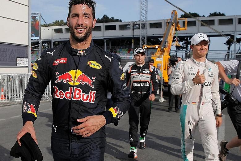 In good cheer in the paddock area after qualifying are (from left) Red Bull's Daniel Ricciardo, Force India's Sergio Perez and Mercedes' Nico Rosberg. Perez will start seventh after a gear-box change penalty, so Ricciardo will begin alongside pole-si