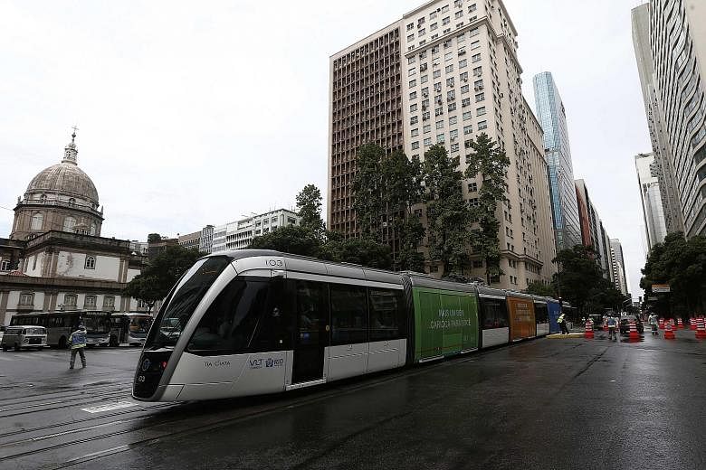 An electric tramway replaces numerous bus lines in the Rio de Janeiro city centre, in the run-up to the Olympics. The state says it is in need of emergency measures to avoid "a total collapse in public security, health, education, transport and envir
