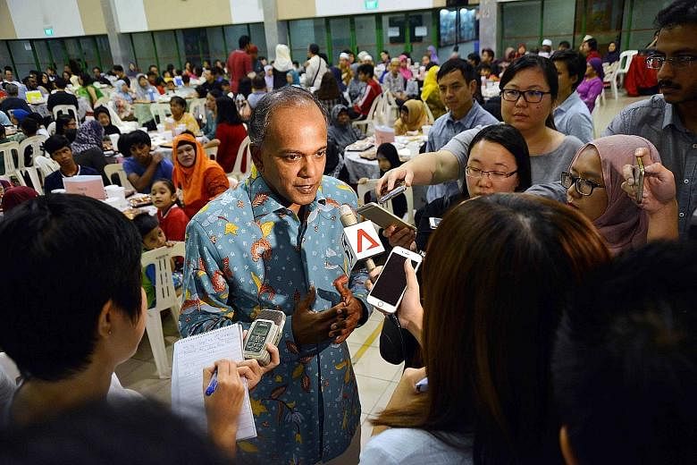 Mr Shanmugam speaking to reporters before the iftar at the Chong Pang Community Club yesterday, where more than 400 residents broke fast together.