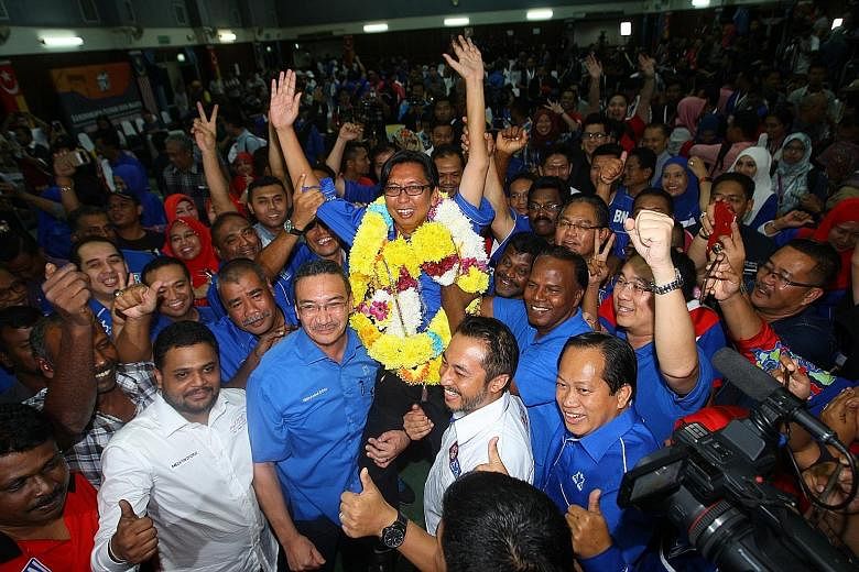 Mr Budiman celebrating after winning the by-election in Sungai Besar. He garnered 16,800 votes, beating the PAS contender's 6,902 votes and Amanah's 7,609. The winning margins for the ruling coalition in Sungai Besar and Kuala Kangsar were larger tha
