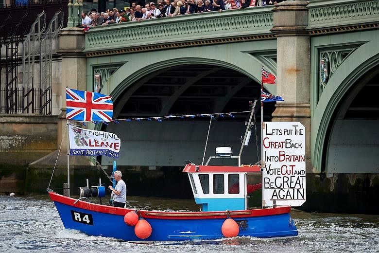 A boat belonging to the "Leave" camp sailing under Westminster Bridge towards the British Houses of Parliament as part of a Brexit flotilla on the River Thames in London on Wednesday.