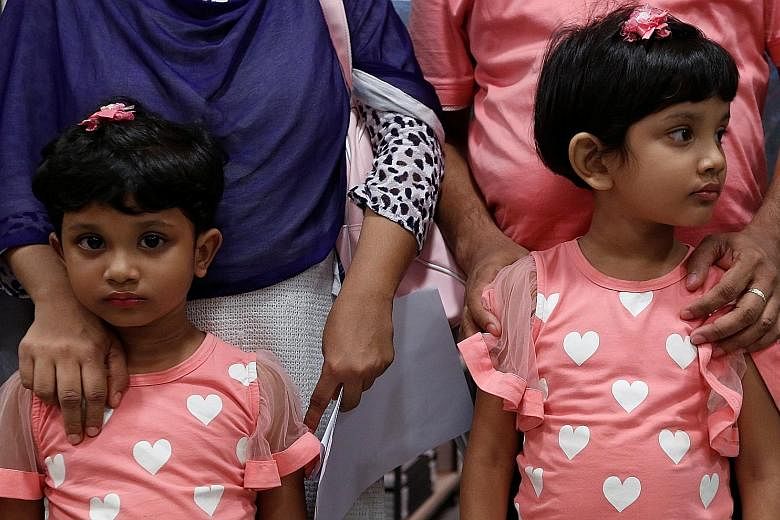 Two refugee children with their parents, who fled Bangladesh, in Hong Kong earlier this month. More than 580 refugee children in the city have been denied the right of abode, making it impossible for young people to get jobs or leave.
