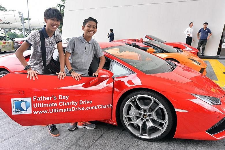 Sixteen-year-old Mohd Nabil Iman (left) and 14-year-old Mohd Naufal Ilham were among those who caught a ride in a supercar yesterday as part of a charity drive to raise funds for The Straits Times School Pocket Money Fund. The drive, a partnership wi