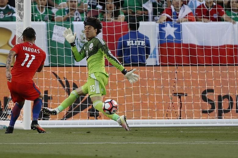 Chile's Eduardo Vargas celebrating after slotting the ball past Mexico goalkeeper Guillermo Ochoa for the first of four goals in a 7-0 win.