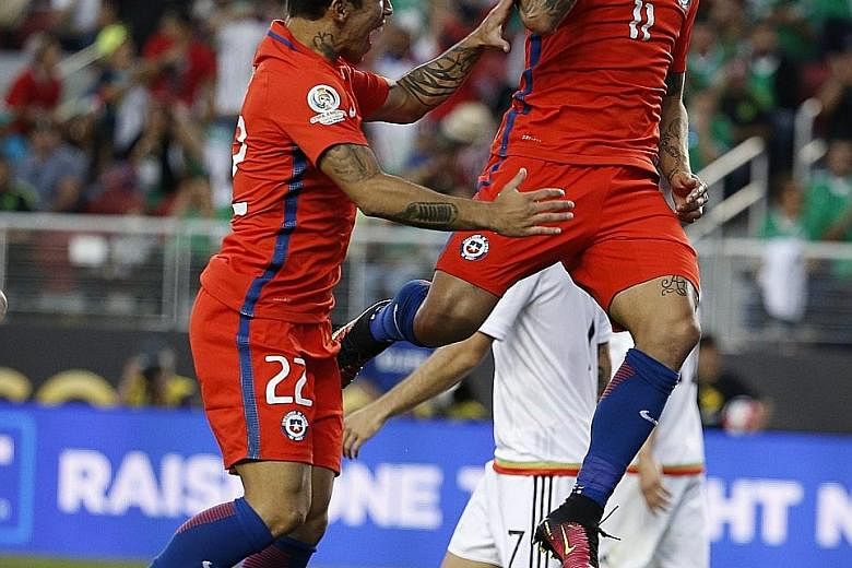 Chile's Eduardo Vargas celebrating after slotting the ball past Mexico goalkeeper Guillermo Ochoa for the first of four goals in a 7-0 win.