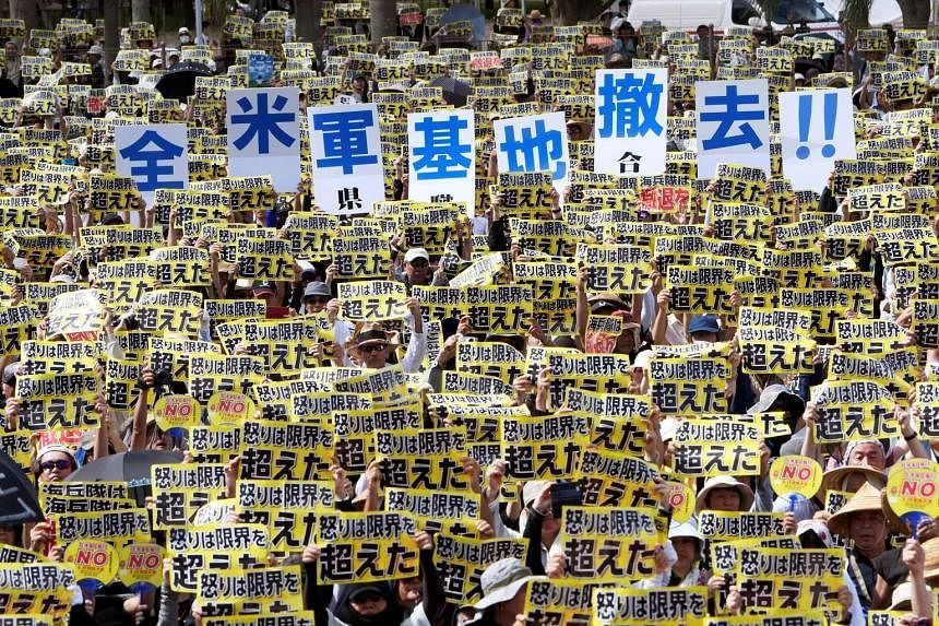 Protesters with placards reading 'Our anger has been pushed over the limit' and 'Remove all American bases' during the one of the biggest rallies against the US military presence on Okinawa in two decades. The protest was triggered after a series of 