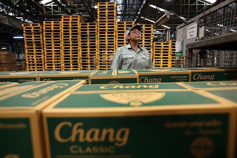 A worker inspecting Thai Beverage Chang beer at a brewery. Thai Beverage has been one of the few companies in the local market to remain resilient over the past month.