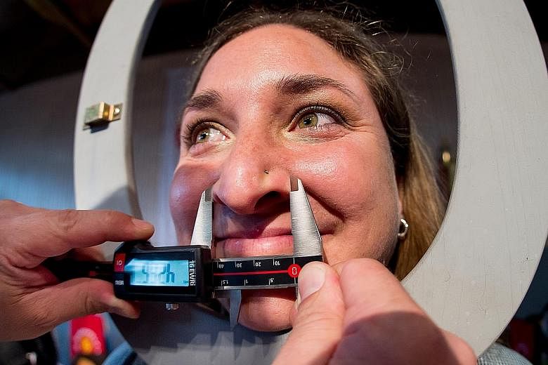 Ms Susanne Kloiber's nose being measured by a judge at the World Championship of Noses in the southern German city of Langenbruck, Bavaria. At 6.95cm in length and 4.26cm in width, her appendage pipped rival big noses, making her the winner of the co