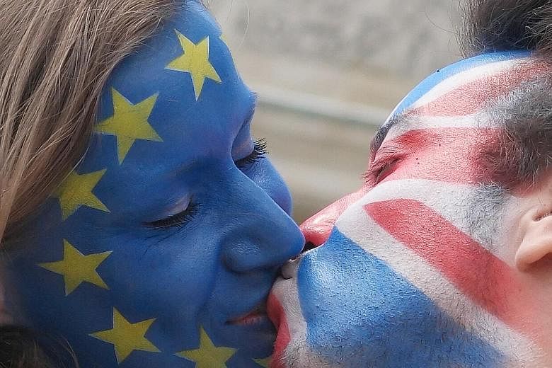 A couple with their faces painted in the flags of the European Union and Britain kissing in Berlin on Sunday. Similar action took place in several cities in Europe, with the aim of encouraging the British to vote in favour of remaining in the EU.