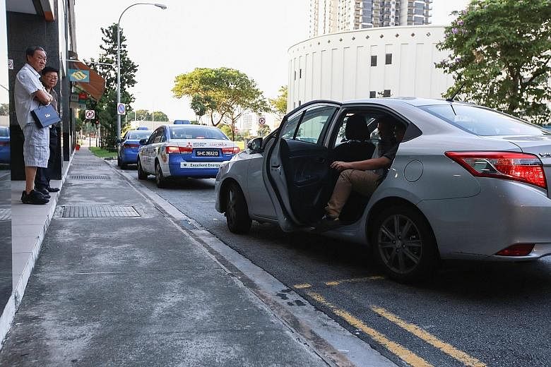 A passenger boarding a Uber car at Bishan Junction 8. The number of applications for taxi-driver vocational licences fell from 9,094 in 2013 to 7,968 last year.