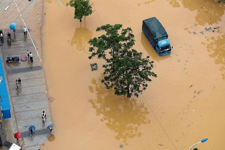 Part of a road is flooded in Jiujiang, Jiangxi Province, on Sunday. Storms pushed water levels in rivers to dangerous levels, leading to crop damage and the collapse of 10,500 houses, Xinhua news agency reported.