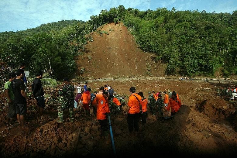 Rescue teams searching for victims of a landslide in Purworejo, Central Java. The national disaster mitigation agency has warned people in the province of the threat of more floods and landslides.