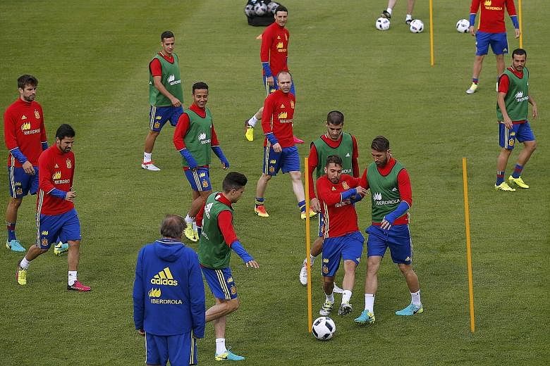 The importance of topping their group to avoid a clash with Italy in the last 16 is not lost on defending champions Spain, seen here at a training session on Sunday. According to midfielder David Silva: "We need to win or draw to stay top of the grou