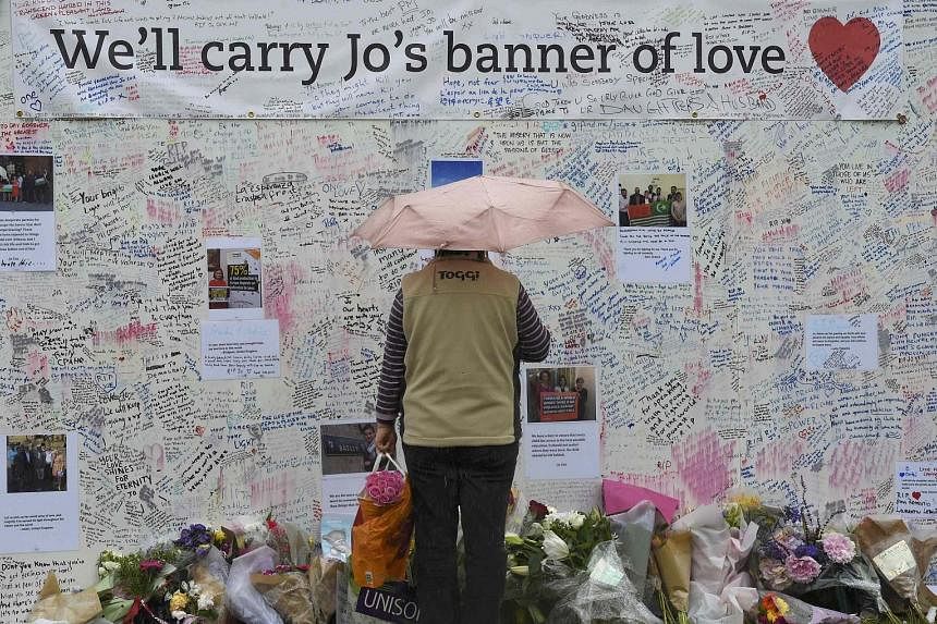 Tributes laid by the Syria Solidarity Campaign during a vigil in remembrance of slain British Labour MP Jo Cox (in photo) in Parliament Square in front of the Houses of Parliament in central London on Sunday.