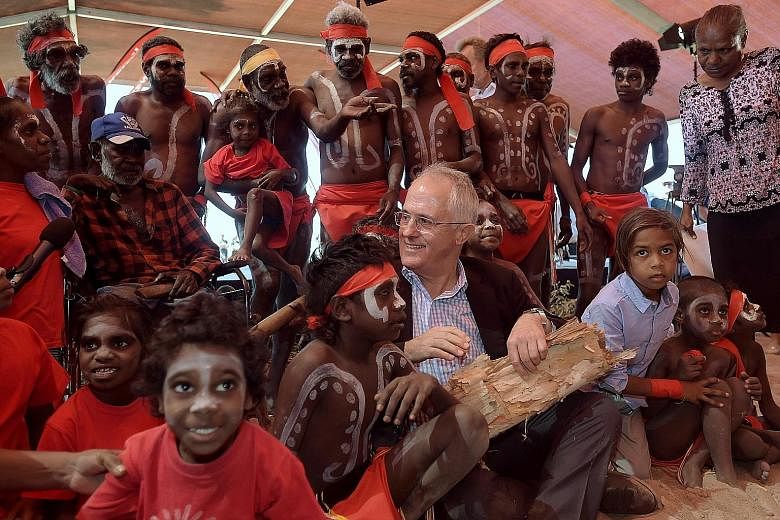 Australian Prime Minister Malcolm Turnbull with Aboriginal dancers at the Kenbi Native land claim ceremony near Darwin, Australia, yesterday. The Kenbi claim, which covers most of Cox Peninsula, was the longest-running Aboriginal land claim case in A