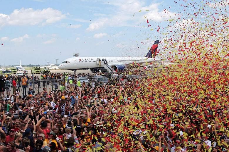 Above: The Cavaliers returning to the Cleveland Hopkins International Airport to a throng of their fans gathering to greet their triumphant team.