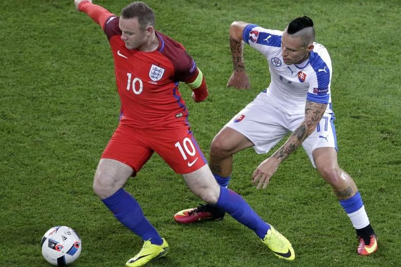 England's Wayne Rooney (left) shielding the ball from Marek Hamsik of Slovakia during the Group B stalemate. The England captain started from the bench and his team eventually settled for the group runners-up spot. 