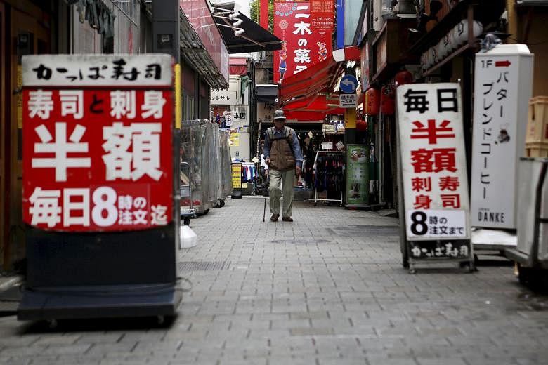 A restaurant row in Tokyo. At their April 27-28 meeting, members of the Bank of Japan held off on expanding monetary stimulus even as global headwinds, a strong yen and soft consumption threatened to derail the country's fragile economic recovery.