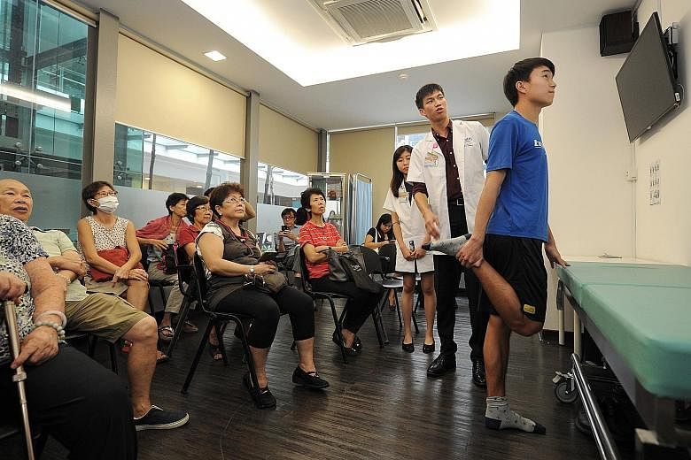 NUS Yong Loo Lin School of Medicine students (from right) Daryl Tham, Jonathan Leong and Goh Yue Shan share with their audience exercises that are suitable for those with osteoarthritis.