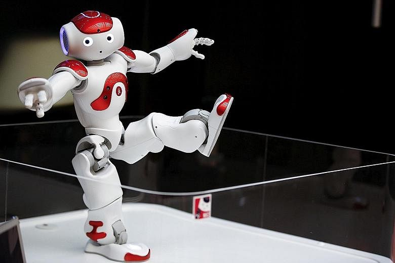 Nao, a humanoid robot, offers basic service information. Robots are being deployed in ever greater numbers in factories and taking on tasks such as personal care or surgery, raising fears over unemployment, wealth inequality and alienation.