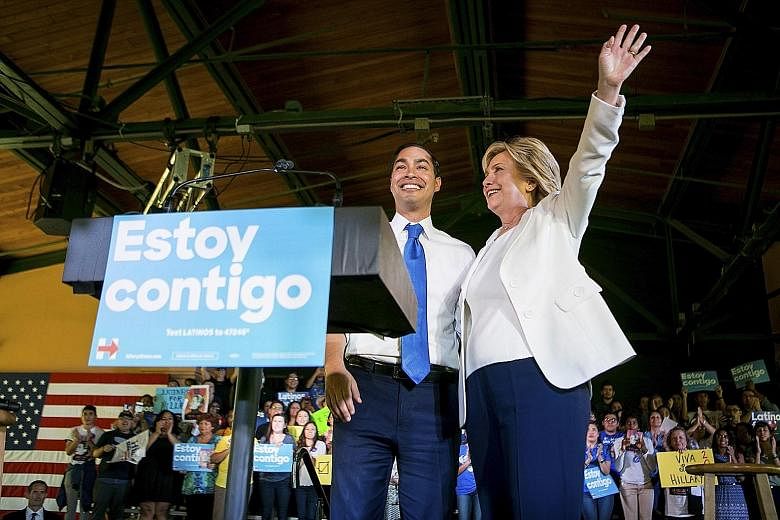 Mrs Clinton with Housing and Urban Development Secretary Julian Castro at a campaign event in San Antonio last October. He is among the three people reported to be early choices for vetting by the Clinton campaign.