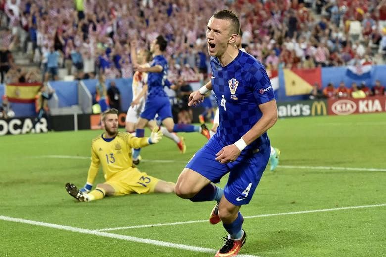 Croatia's Ivan Perisic wheeling away in celebration after beating Spain's David de Gea at his near post. The midfielder's late winner consigned the holders to their first European Championship defeat since 2004.