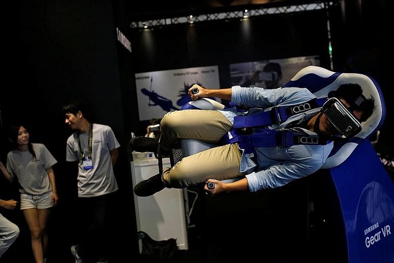A visitor with the Samsung Gear VR - a virtual reality headset - at an exhibition in Taiwan recently. Regional companies with cash piles include Samsung Electronics, where cash and short-term investments accounted for between 30 per cent and 43 per c