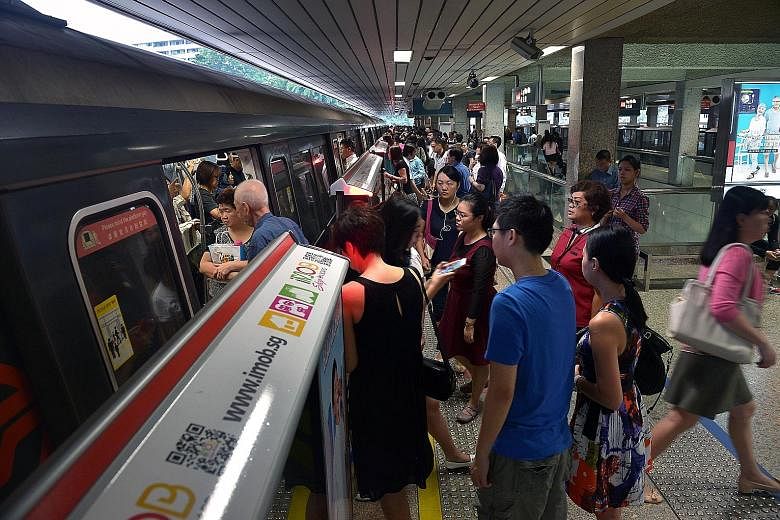 The early morning rush hour at the Ang Mo Kio MRT station yesterday. More than 65,000 commuters benefit every day from the free train ride scheme, which began in 2013 and applies to those who exit 18 MRT stations in the city area on weekdays before 7