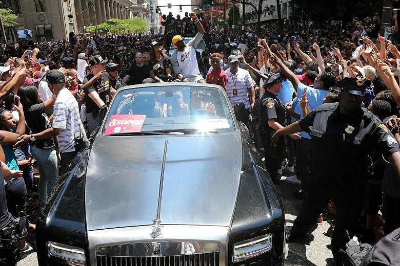 Cleveland Cavaliers hero LeBron James waving to the crowd during a parade to celebrate winning the 2016 NBA Championship in downtown Cleveland on Wednesday.