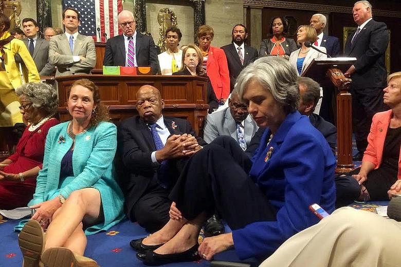 Democrats staging a sit-in on the House floor to demand votes on gun-control legislation on Wednesday. The picture was tweeted from the House floor by Representative Katherine Clark (in blue). The Democrats were led in their sit-in by Representative 