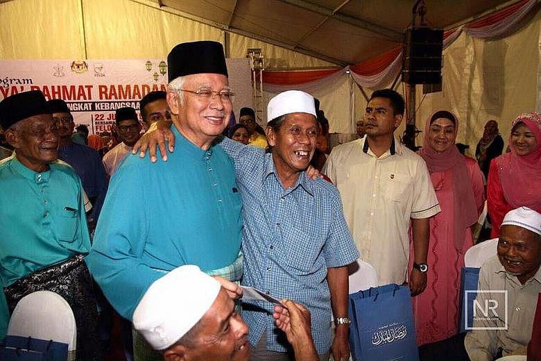Mr Najib at a Ramadan Blessings event in his Pekan home town in Pahang on Wednesday. The Malaysian Prime Minister seems to have recovered from fending off a corruption scandal tied to state fund 1MDB in the past year. Observers say he may call an ele