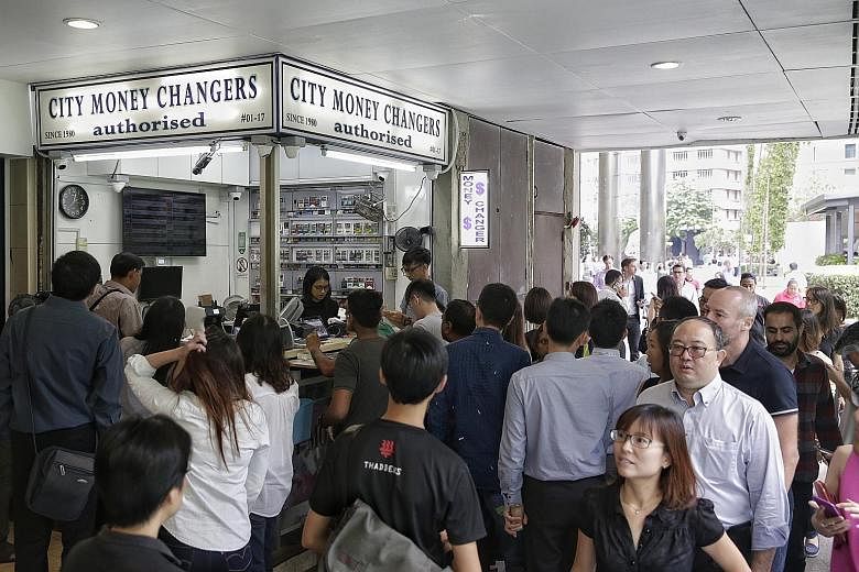 Crowds flocked to money changers in Raffles Place hoping to snap up sterling cheaply after the rate plunged.