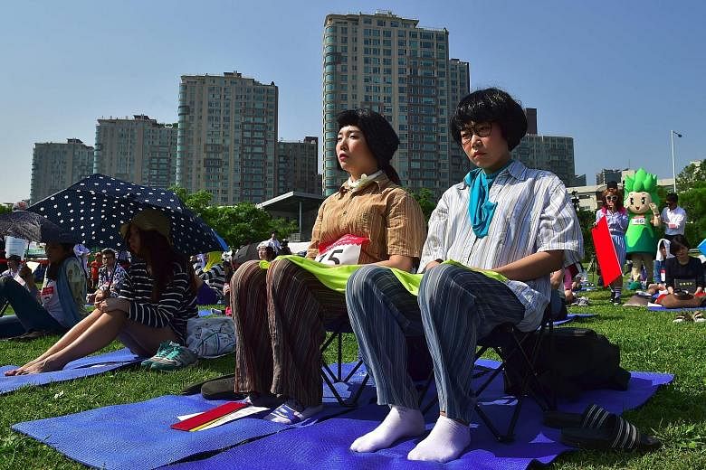 South Koreans taking part in Seoul's "space-out" competition on May 22, in which participants were required to sit idly for hours without talking, sleeping, eating or using any electronic devices. The competition, which has been running since 2014, i