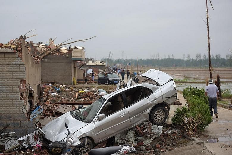 The aftermath in Funing county, Yancheng, yesterday after a tornado ripped through the area on Thursday. Whole villages were levelled by the tornado and accompanying hailstorms.