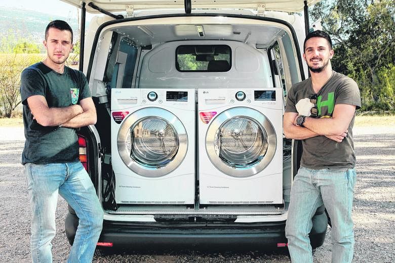 Mr Spiliopoulos (left) and Mr Tsonas hope that their "Ithaca Laundry" - a van refitted with washing machines - will help the homeless improve their self-esteem and increase their dignity.