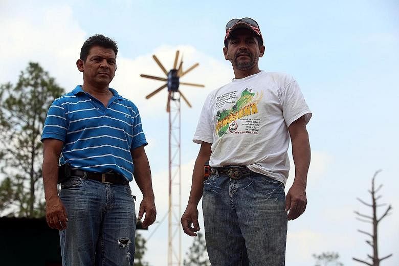 Mr Oscar Pagoada (far left) and Mr Javier Caceres were forced into action by the 12-hour electricity blackouts which affect remote Honduran communities.