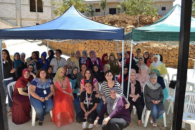 Ms Saba and a group of beneficiaries during a visit of Unicef officials in Akkar. Ms Saba leads Akkar Network for Development, an organisation that seeks to protect women and teenage girls from violence.