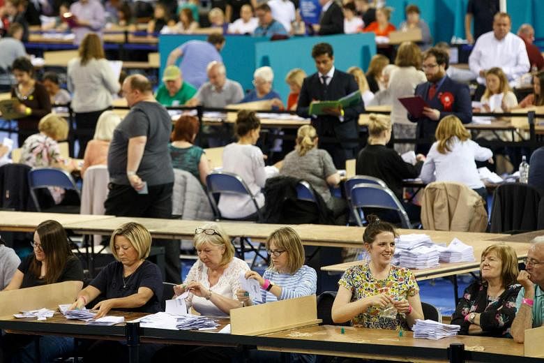 Ballots being counted at a centre in Glasgow (above), Scotland, and the first ballot boxes being opened at a centre in Belfast, Northern Ireland. The Scots voted strongly to remain in the EU, as did Northern Ireland. 
