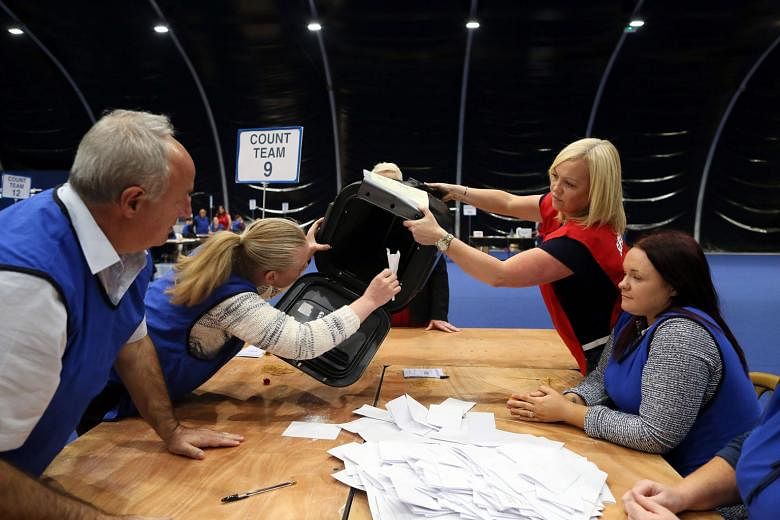 Ballots being counted at a centre in Glasgow, Scotland, and (above) the first ballot boxes being opened at a centre in Belfast, Northern Ireland. The Scots voted strongly to remain in the EU, as did Northern Ireland. 