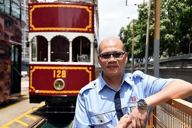 Tram captain Chan Siu Chung remembers a memorable trip when he helped a young man propose - successfully - to his girlfriend on board an antique tram (behind him).