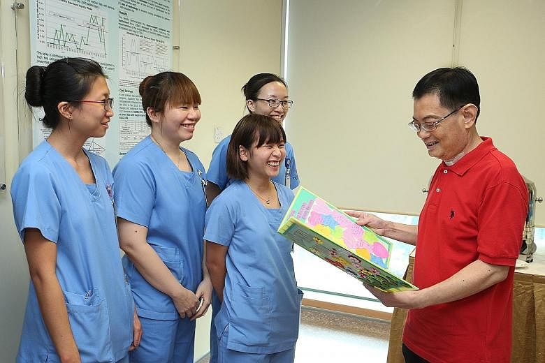 Mr Heng receiving a "get well" card from Tan Tock Seng Hospital nurses. The Finance Minister yesterday thanked all those who had looked after him during his stay in hospital. News of his discharge was welcomed by colleagues and Singaporeans.