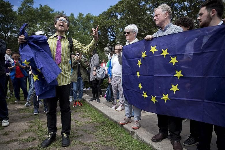British demonstrators holding EU flags as they protested yesterday against the outcome of the Brexit referendum. The Leave camp won the support of 51.9 per cent of voters, against 48.1 per cent in favour of the Remain camp. The turnout for last Thurs