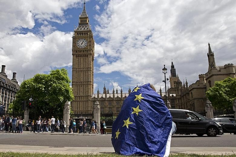 A demonstrator draped in the EU flag in London protesting last Saturday against the outcome of the referendum.